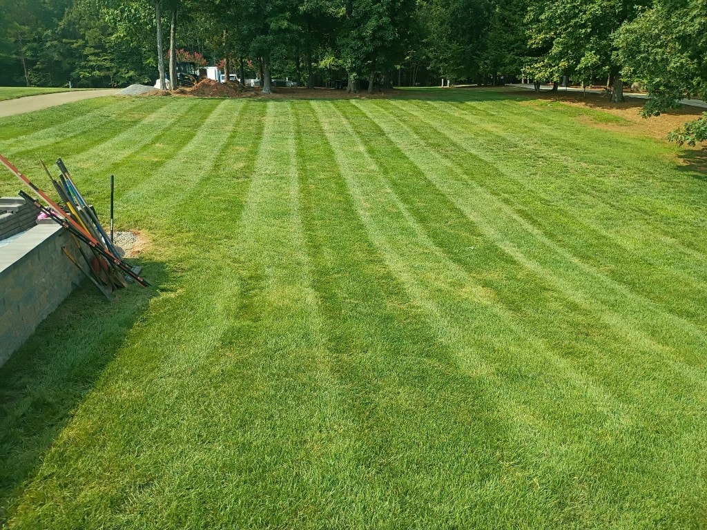 Large residential lawn with sharp professional mowing stripes